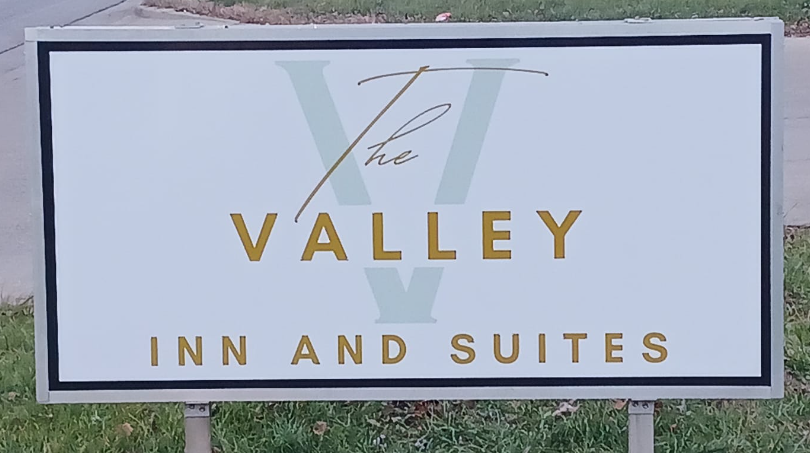 Sign outside in the grass The Valley Inn and Suites